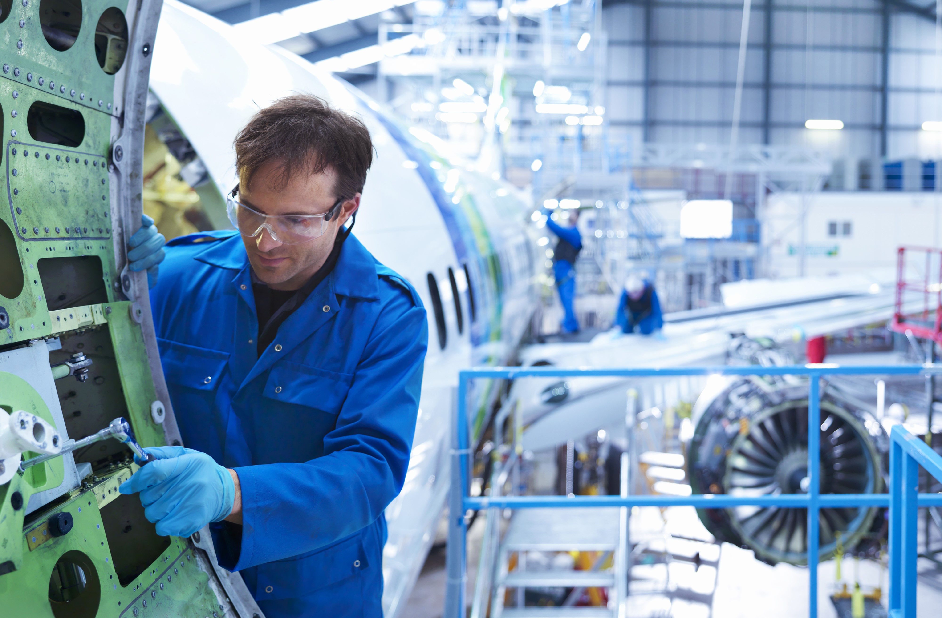 Airplane being repaired by the mechanics.