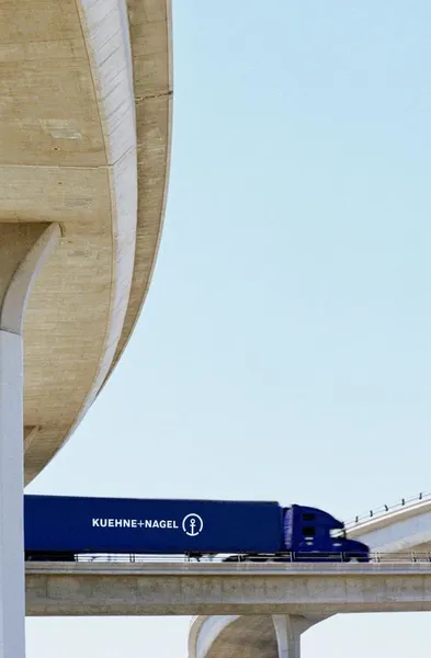 Side view of a Kuehne+Nagel truck on the bridge